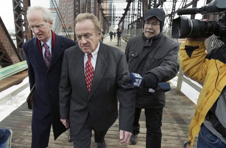 Michael McLaughlin, former director of the Chelsea Housing Authority, will be sentenced on May 14th. Above, he leaves U.S. District Court in Boston with his lawyer on Tuesday. (AP/Charles Krupa) 