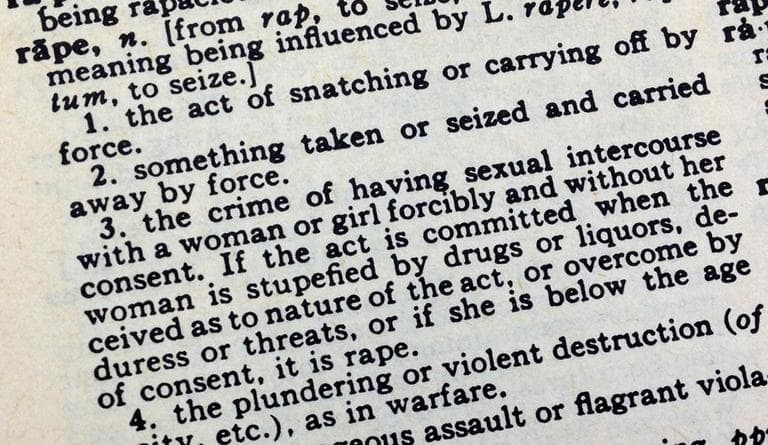 Rape survivor Lydia Cuomo is challenging the legal definition of rape. Pictured is a dictionary definition. (Here &amp; Now)