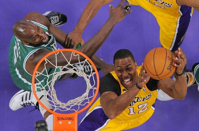 Los Angeles Lakers center Dwight Howard, right, puts up a shot as Boston Celtics forward Kevin Garnett defends. (AP/Mark J. Terrill)