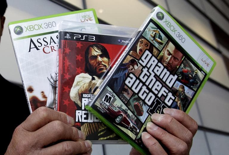 Calif. State Sen. Leland Yee holds up three video games after a news conference following the 2011 Supreme Court ruling that it is unconstitutional to bar children from buying or renting violent video games. (Paul Sakuma/AP)