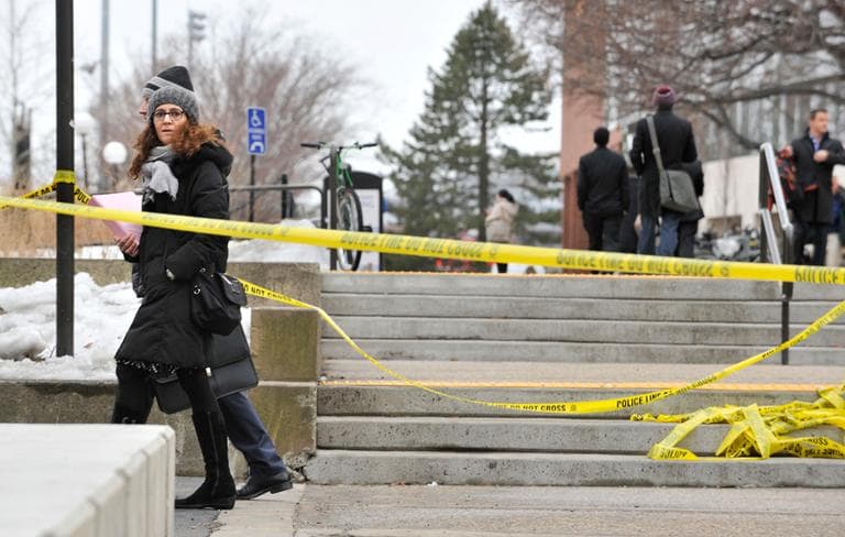 Pedestrians walk by police tape on the MIT campus in Cambridge after police responded to reports of a gunman on campus that police later said were unfounded, Saturday. (Josh Reynolds/AP)