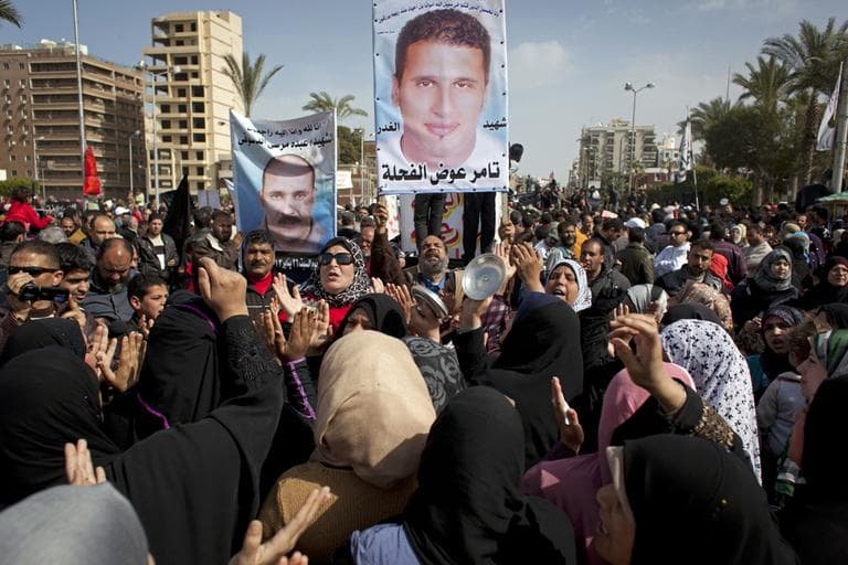 In this Friday, Feb. 22, 2013 photo, Egyptian protesters chant anti-President Mohammed Morsi slogans and carry posters with pictures of victims of recent violence and their names in Port Said, Egypt. (Nasser Nasser/AP)