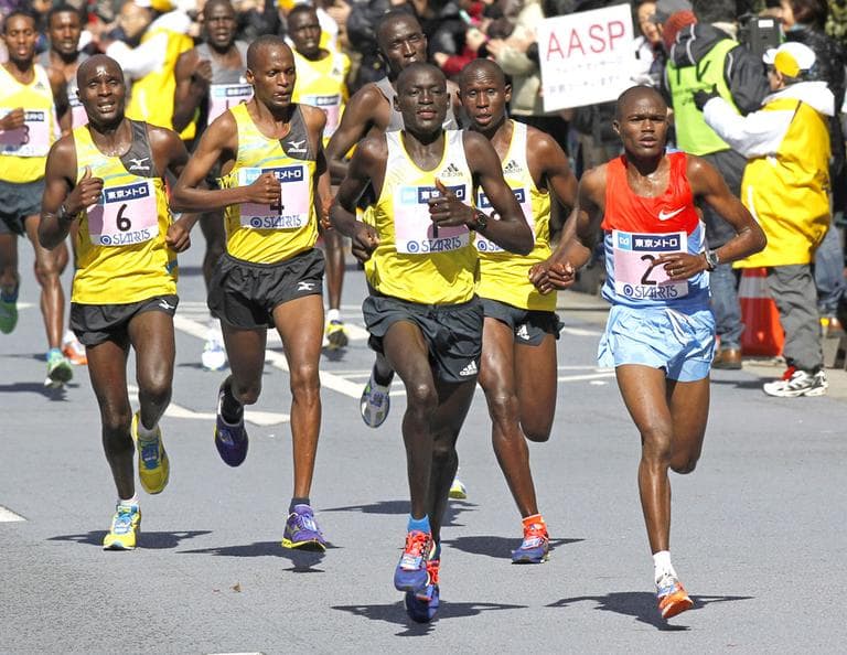 Dennis Kimetto of Kenya, center, leads the pack on his way to winning the men's race of the Tokyo Marathon on Sunday. (AP/Shuji Kajiyama)