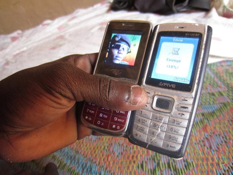 A peer-to-peer (P2P) file transfer from cellphone to cellphone is pictured in Gao, Mali, in 2012. (Christopher Kirkley)