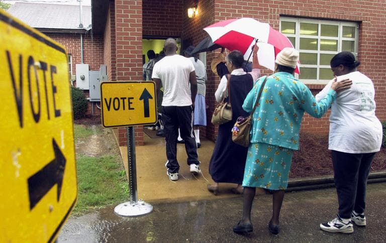 A line of voters stand in the rain outside this Montgomery, Ala., polling place as they wait to cast their ballots in the general election on Tuesday, Nov. 7, 2000. (Dave Martin/AP)