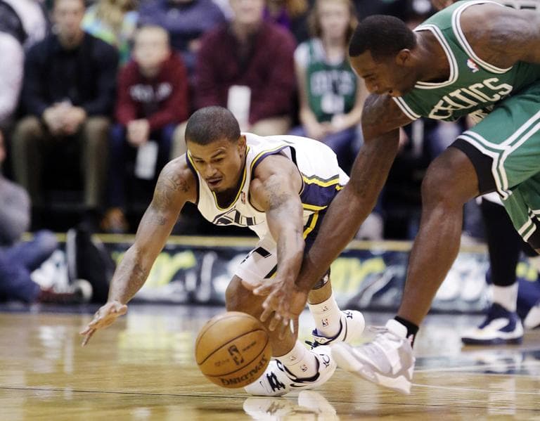 Utah&#039;s Earl Watson and Boston&#039;s Brandon Bass chase after a loose ball in the first quarter. (AP)