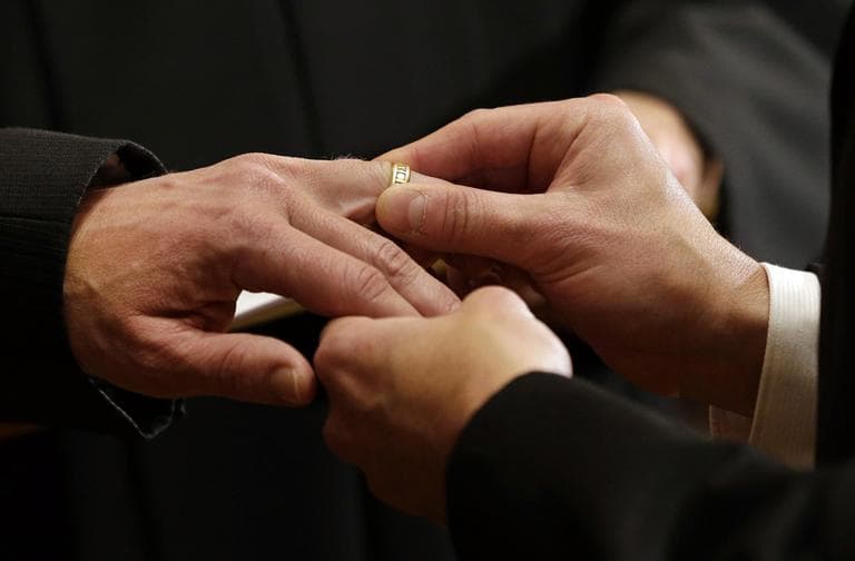 Thomas Rabe, right, places a wedding ring on Robert Coffman's finger during a marriage ceremony at City Hall in Baltimore, Tuesday, Jan. 1, 2013. (Patrick Semansky/AP)