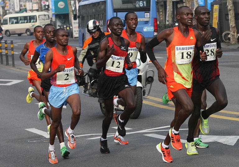 Wilson Loyanae Erupe of Kenya (18) is seen  leading a pack of runners during the men's race of the Seoul International Marathon in Seoul, South Korea, March 18, 2012. Erupe is among three Kenyan runners suspended for in February 2013. (Ahn Young-joon/AP)