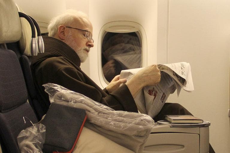 Boston Cardinal Sean O’Malley on a flight to Rome on Tuesday (Courtesy Gregory L. Tracy/The Pilot)