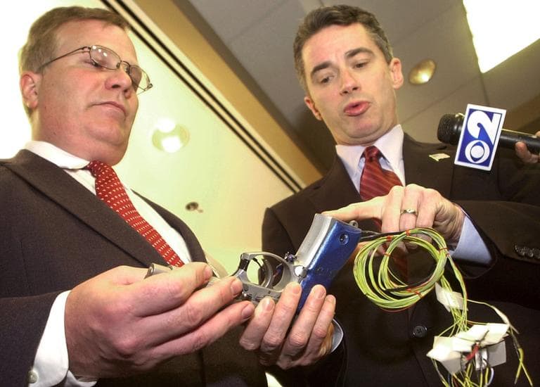 New Jersey Gov. James E. McGreevey, right, points to the handle of a &quot;smart gun&quot; with grip recognition technology, held by the gun's inventor Michael Recce, associate professor of information systems at New Jersey Institute of Technology in Newark, N.J. in January 2004. (Mike Derer/AP)