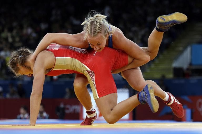 Sofia Mattsson of Sweden competes against Valeriia Zholobova of Russia (in red) during a 55-kg women's freestyle wrestling competition at the 2012 Summer Olympics Aug. 9, 2012, in London. (Paul Sancya/AP)
