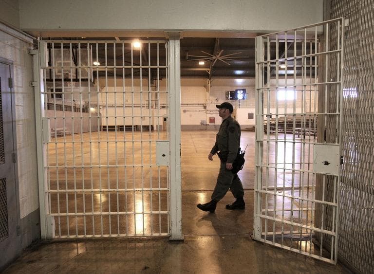 A correctional officer walks in a gymnasium that housed overflow prisoners in Tracy, California (Rich Pedroncelli/AP)