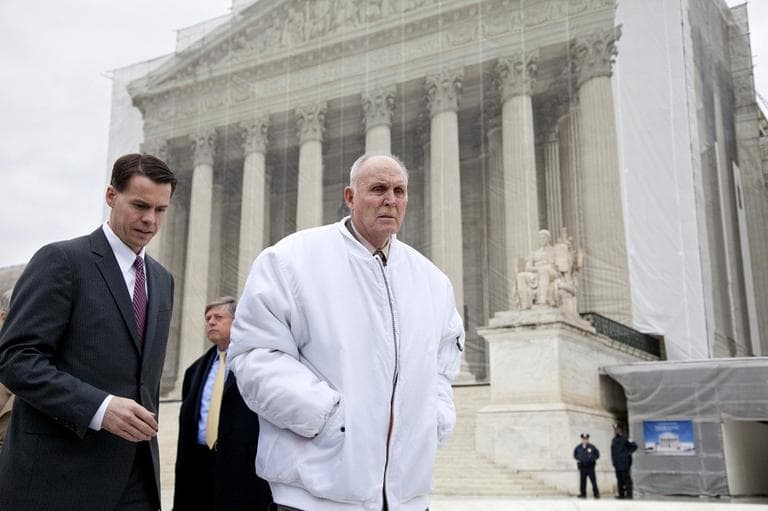 Vernon Hugh Bowman, a 75-year-old Indiana soybean farmer, accompanied by his attorney Mark Walters, walk outside the Supreme Court in Washington (J. Scott Applewhite/AP)