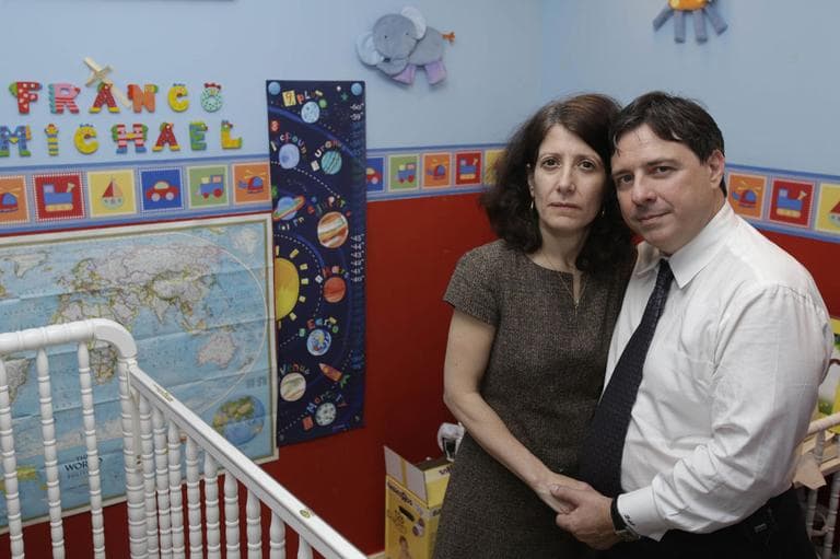 In this Jan. 30, 2013 photo, Drew and Frances Pardus-Abbadessa pose for a picture in the nursery originally intended for their would-be adopted son, at their apartment in New York. The boy's Russian name is Vladimir, but they hope one day to be able to name him Franco Michael, the name still displayed on the wall. (AP)