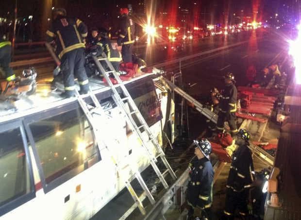 Firefighters remove injured passengers from a bus that hit an bridge as it traveled on Soldiers Field Road in the Allston neighborhood of Boston on Saturday night. Officials said the bus carrying 42 people was traveling from Harvard University home to Pennsylvania when it struck the overpass. (Boston Fire Department)