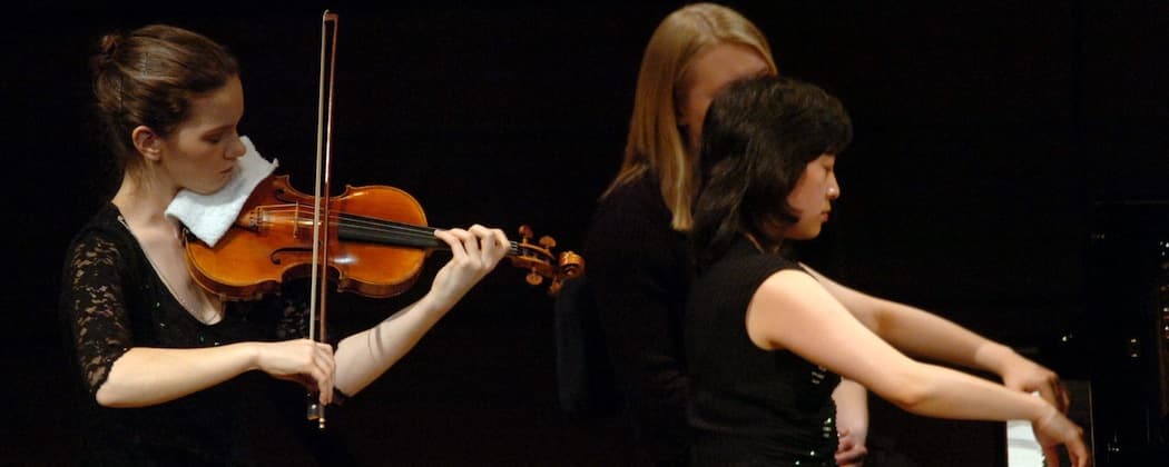 Hilary Hahn and Natalie Zhu in a 2005 concert.  (Photo courtesy of AP//Keystone/Sigi Tischler)