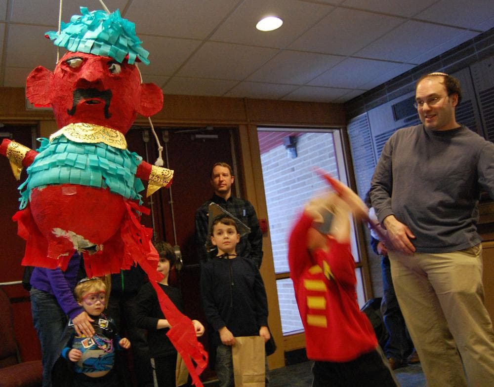 Kobe Richberg bashes the  Haman piñata during Temple Shalom's Purim Party. (Greg Cook)