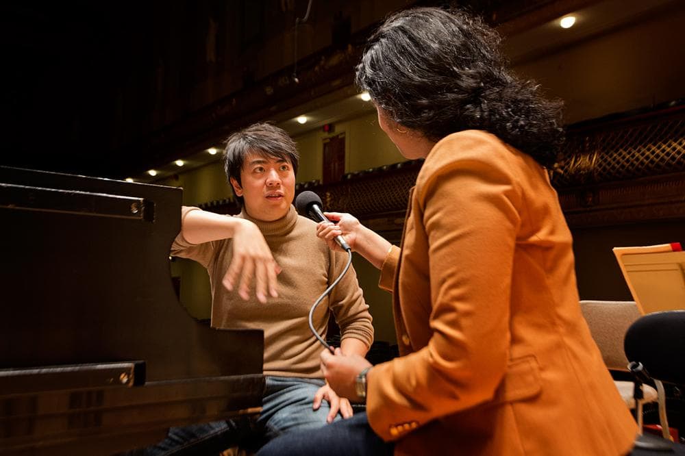 Classical pianist Lang Lang being interviewed by Meghna Charkrabarti at Boston Symphony Hall. (Jesse Costa/WBUR)