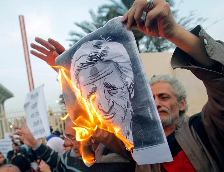 Egyptian activists burn a poster depicting U.S. Secretary of State John Kerry during a protest outside the Egyptian foreign ministry in Cairo, Egypt, Saturday, March 2, 2013. (Amr Nabil/AP)