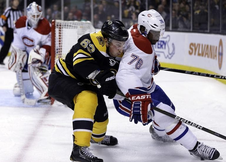 Boston Bruins left wing Brad Marchand (63), center, keeps pressure on Montreal Canadiens defenseman P.K. Subban.(AP/Steven Senne)