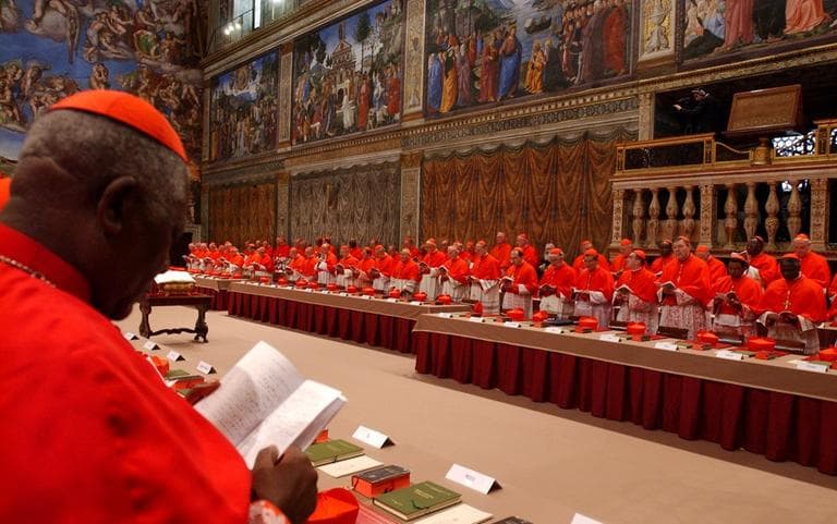 In this April 18, 2005, photo released by the Vatican paper L'Osservatore Romano, Cardinal Christian Wiyghan Tumi of Cameroun joins fellow cardinals in prayer inside the Sistine Chapel at the Vatican, at the beginning of the conclave. (Osservatore Romano/AP)