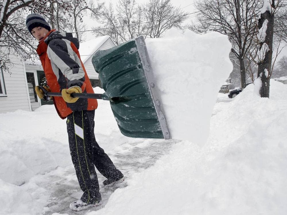 Mike Flynn of Minneapolis was out shoveling snow early Tuesday. (Jim Mone/AP)
