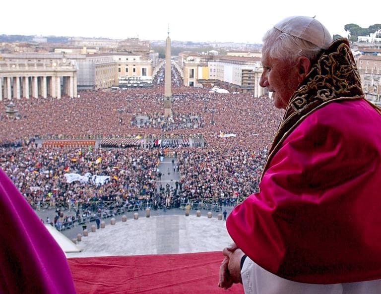 The crowd in St. Peter's Square can be seen behind the new Pope Benedict XVI, after he greets and blesses the crowd for the first time, from the central balcony of St. Peter's Basilica at the Vatican, Tuesday, April 19, 2005 (click to enlarge). (L'Osservatore Romano/AP)