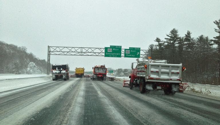 A fleet of snow plows barrels down Interstate-95 North in Georgetown Friday afternoon. (Jesse Costa/WBUR)