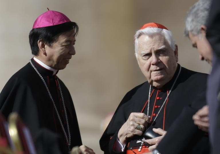 Cardinal Bernard Law, right, speaks with unidentified prelates as he attends Pope Benedict XVI&#039;s last general audience in St. Peter&#039;s Square at the Vatican, Feb. 27, 2013 (AP)