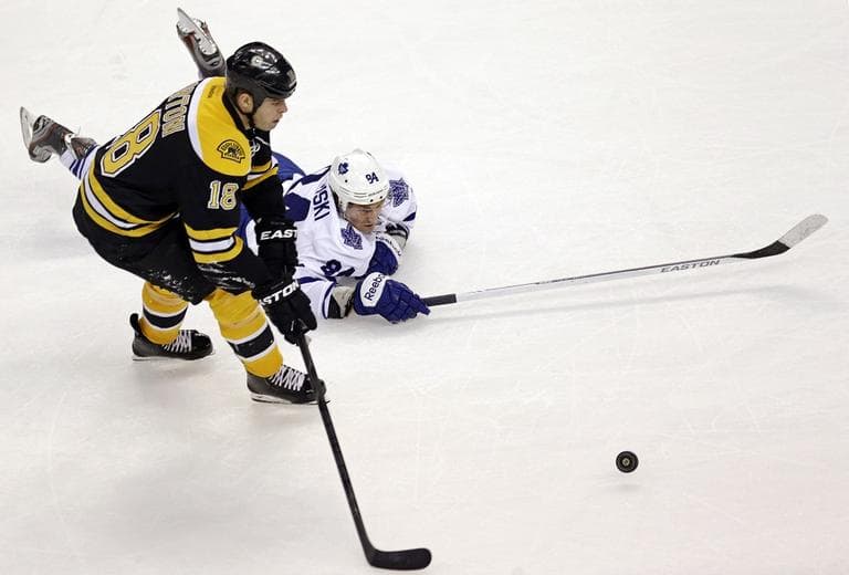 Toronto Maple Leafs center Mikhail Grabovski, of Belarus, dives as he tries to knock the puck away from Boston Bruins right wing Nathan Horton (18). (AP/Charles Krupa)