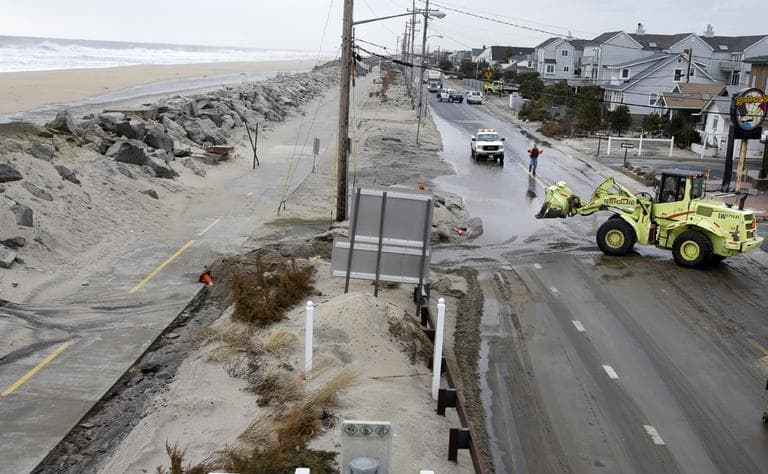 Crews clear a flooded road Thursday, March 7, 2013, in Sea Bright, N.J., after an overnight storm caused the ocean to breach a temporary dune. (Mel Evans/AP)