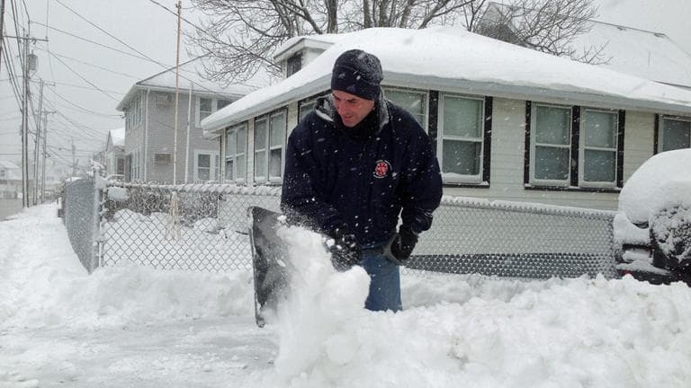 A Winthrop resident shovels snow Friday morning. (Jesse Costa/WBUR)
