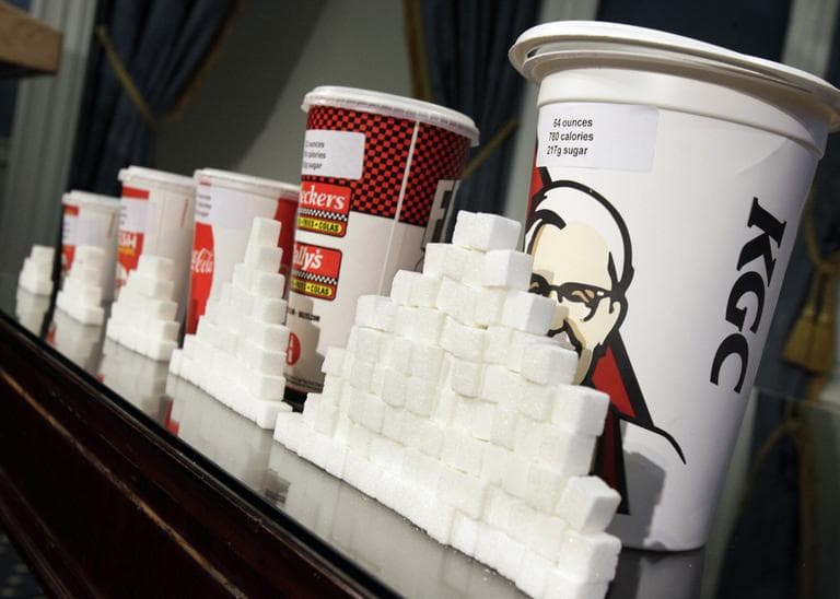 A display of various size soft drink cups next to stacks of sugar cubes at a news conference at New York&#039;s City Hall on  May 31, 2012. (Richard Drew/AP)