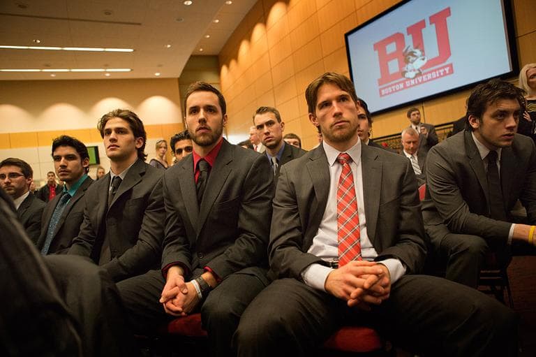 Members of the BU hockey team watch as Jack Parker announces his retirement at Agannis Arena on Monday. (Jesse Costa/WBUR)