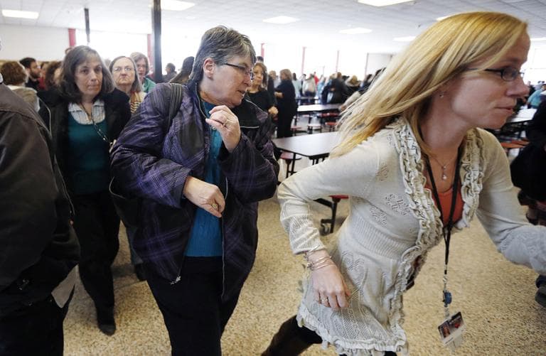 Participants rush out of the cafeteria after hearing gun shots during a lockdown exercise at Milford High School in Milford, Mass., Friday, March 15, 2013. (Michael Dwyer/AP)