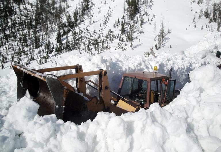 This image provided by the National Park Service shows a front loader clearing off a snow-blocked Sylvan Pass inside Yellowstone National Park May 11, 2011 in Montana. (National Park Service/AP)