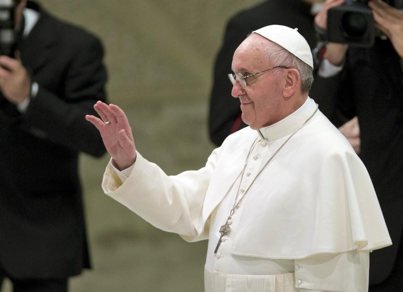 Pope Francis waves as he arrives for a meeting with the media Saturday. (AP-Photo/Alessandra Tarantino)