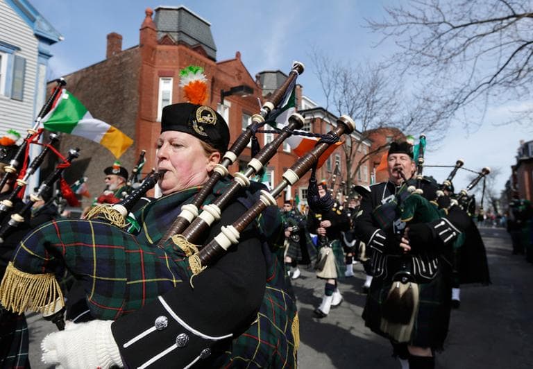 A members of the Catamount Pipe Band, from Montpelier, Vt., left, blows her bagpipes while marching in a St. Patrick's Day Parade, in South Boston, Sunday, March 17, 2013. (Steven Senne/AP)