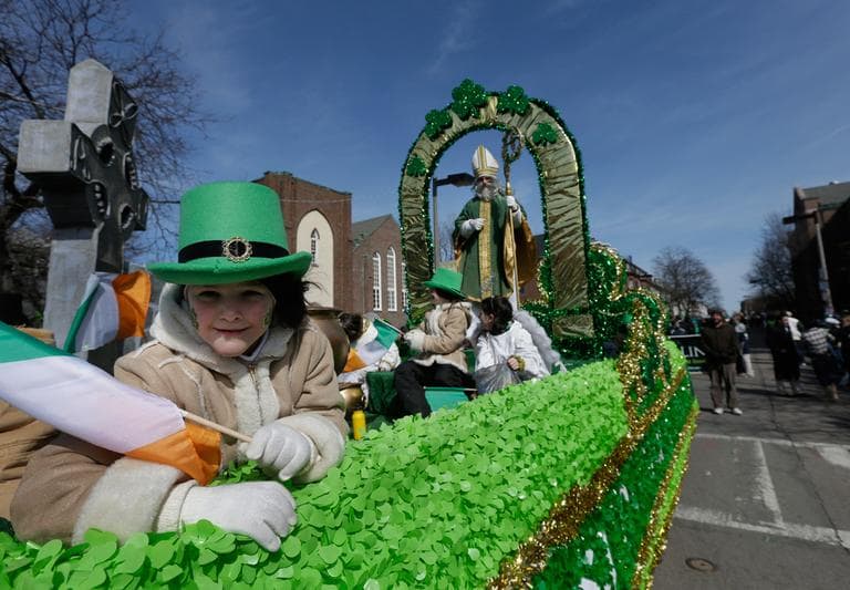 A girl holds an Irish flag while in costume on a St. Patrick's Day float in the St. Patrick's Day Parade, South Boston, Sunday, March 17, 2013. (Steven Senne/AP)