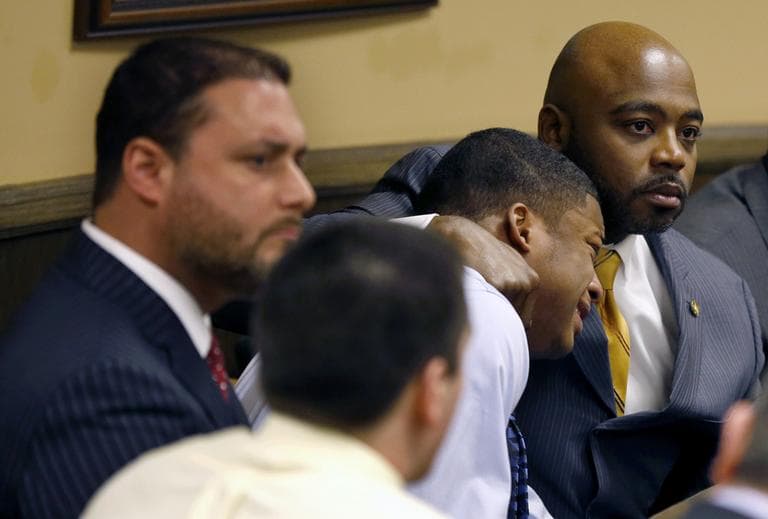 Defense attorney Walter Madison, right, holds his client, 16-year-old Ma'Lik Richmond, second from right, while defense attorney Adam Nemann, left, sits with his client Trent Mays, foreground, 17, as Judge Thomas Lipps pronounces them both delinquent on rape and other charges after their trial in juvenile court in Steubenville, Ohio, Sunday, March 17, 2013. (Keith Srakocic/AP)