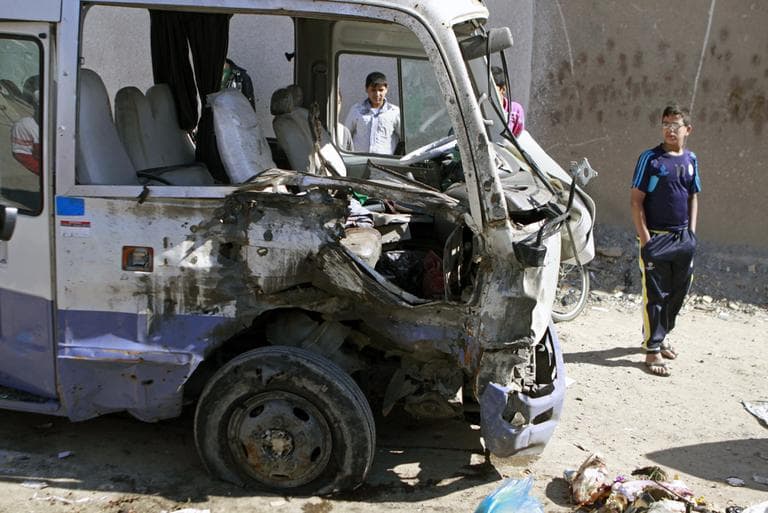 Children inspect a bus destroyed in a car bomb attack in the Shiite stronghold of Sadr City, Baghdad, Iraq, Tuesday, March 19, 2013. (Karim Kadim/AP)