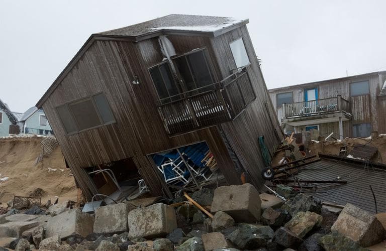 The winter storm that battered New England’s coastline last week ripped two Plum Island homes off their foundation and left them partially collapsed into the ocean. (Jesse Costa/WBUR)