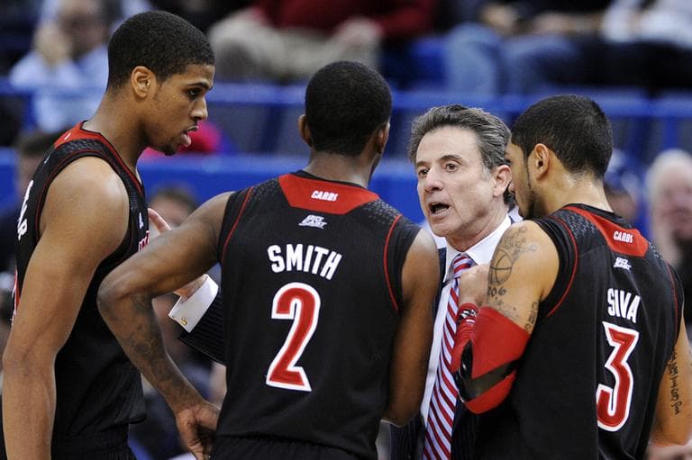 Louisville head coach Rick Pitino speaks with his players during the second half of their NCAA college basketball game against Connecticut in Hartford, Conn., Monday, Jan. 14, 2013. (Fred Beckham/AP)