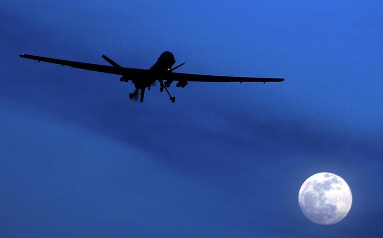 An unmanned U.S. Predator drone flies over Kandahar Air Field, southern Afghanistan, on a moon-lit night, Jan. 31, 2010. (Kirsty Wigglesworth/AP)