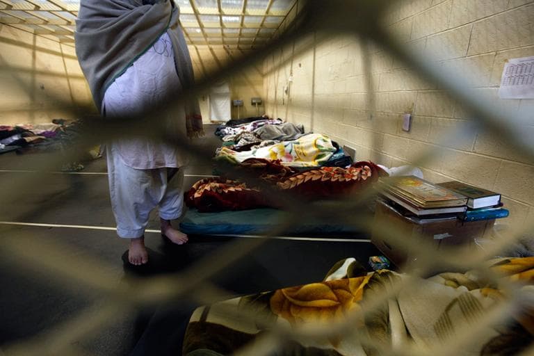 This March 23, 2011, file photo shows Afghan detainees through a wire mesh fence inside the Parwan detention facility near Bagram Air Field in Afghanistan. (Dar Yasin/AP File)