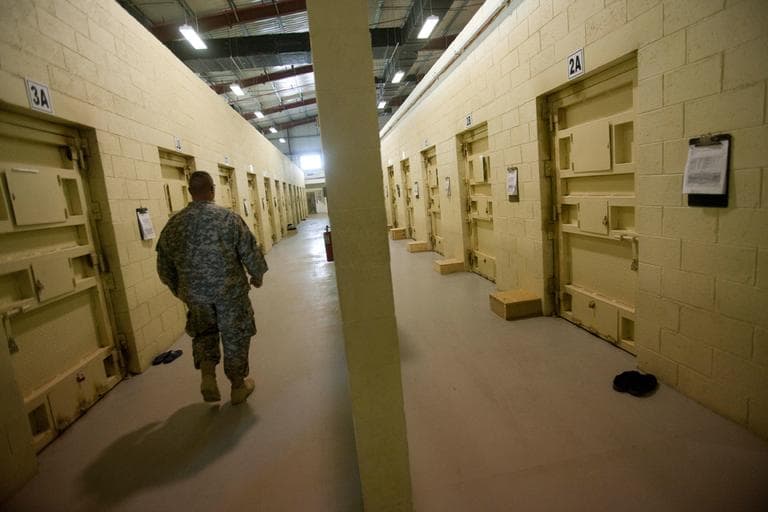 This Sept. 27, 2010, file photo reviewed by the U.S. military, shows a U.S. military guard walking a corridor between detainee cells at the Parwan detention facility near Bagram, north of Kabul, Afghanistan. (David Guttenfelder/AP File)