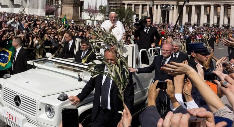 Pope Francis waves at a cheering crowd as he wades through St. Peter's Square at the Vatican, Sunday, March 24, 2013. (Domenico Stinellis/AP)