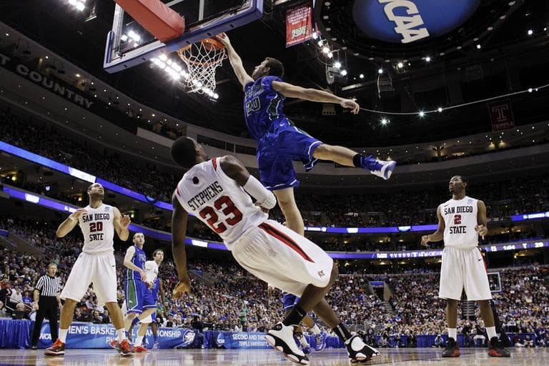 Florida Gulf Coast's Chase Fieler, top, dunks over San Diego State's Deshawn Stephens during the first half of a third-round game of the NCAA college basketball tournament, Sunday, March 24, 2013, in Philadelphia. (Matt Slocum/AP)