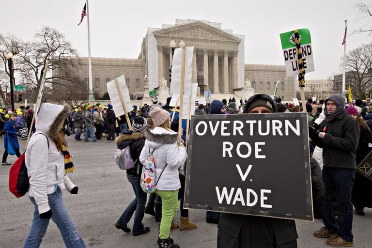 Anti-abortion activists march past the U.S. Supreme Court in Washington, Friday, Jan. 25, 2013, as they observe the 40th anniversary of the Roe v. Wade decision. (J. Scott Applewhite/AP)