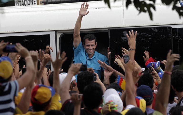 Venezuela's opposition presidential candidate Henrique Capriles waves to supporters during a rally in Carora,  Lara State,  Venezuela, Sunday, March 24, 2013.  Capriles will run against a the late president Hugo Chavez'  hand-picked successor  Nicolas Maduro on April 14. (Ariana Cubillos/AP)